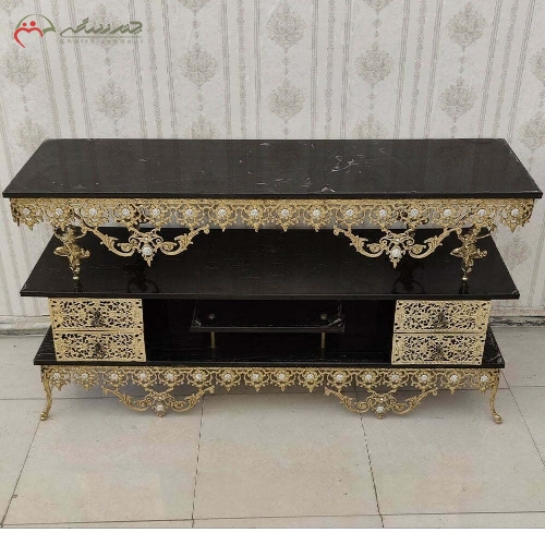 میز تلویزیون برنزی چهار کشو با پایه های طرح فرشته و رویه هایگلس مشکی با ضمانت کد 9853 - چترزندگی